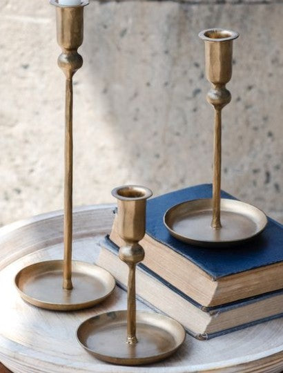 Set of three gold-tone plate candlestick holders with round bases