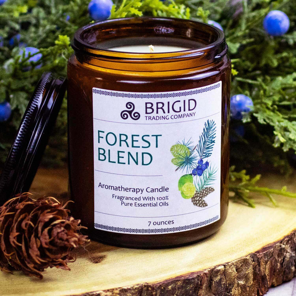 Amber glass soy wax candle jar with Forest Blend label and BRIGID Trading Company.