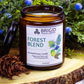 Amber glass soy wax candle jar with Forest Blend label and BRIGID Trading Company.