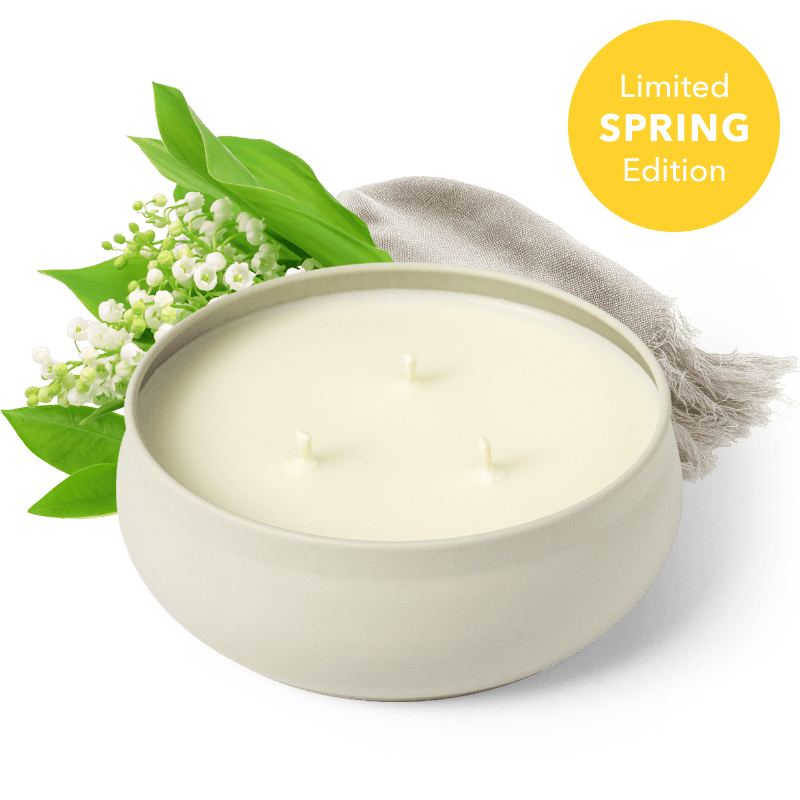 White 3-wick candle in round cream jar, three flames visible