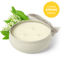 White 3-wick candle in round cream jar, three flames visible