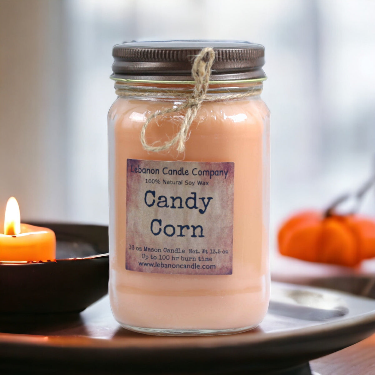 Peach jar candle with metal lid and Candy Corn label, twine tied around neck