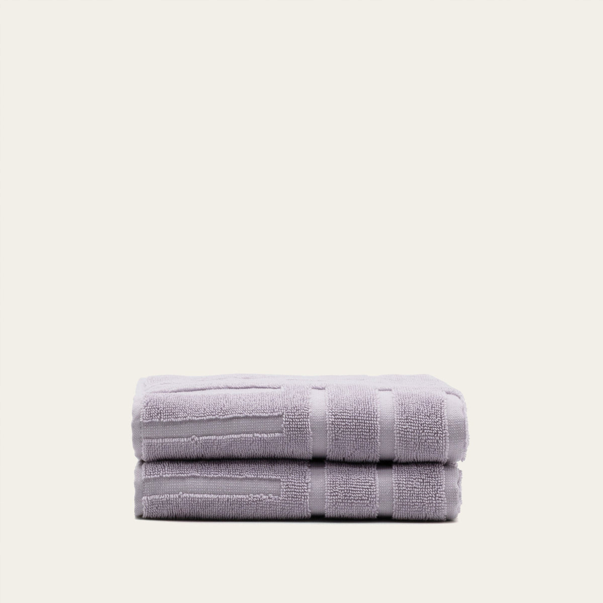Lavender cotton towels, folded stack with terry loops and horizontal banding