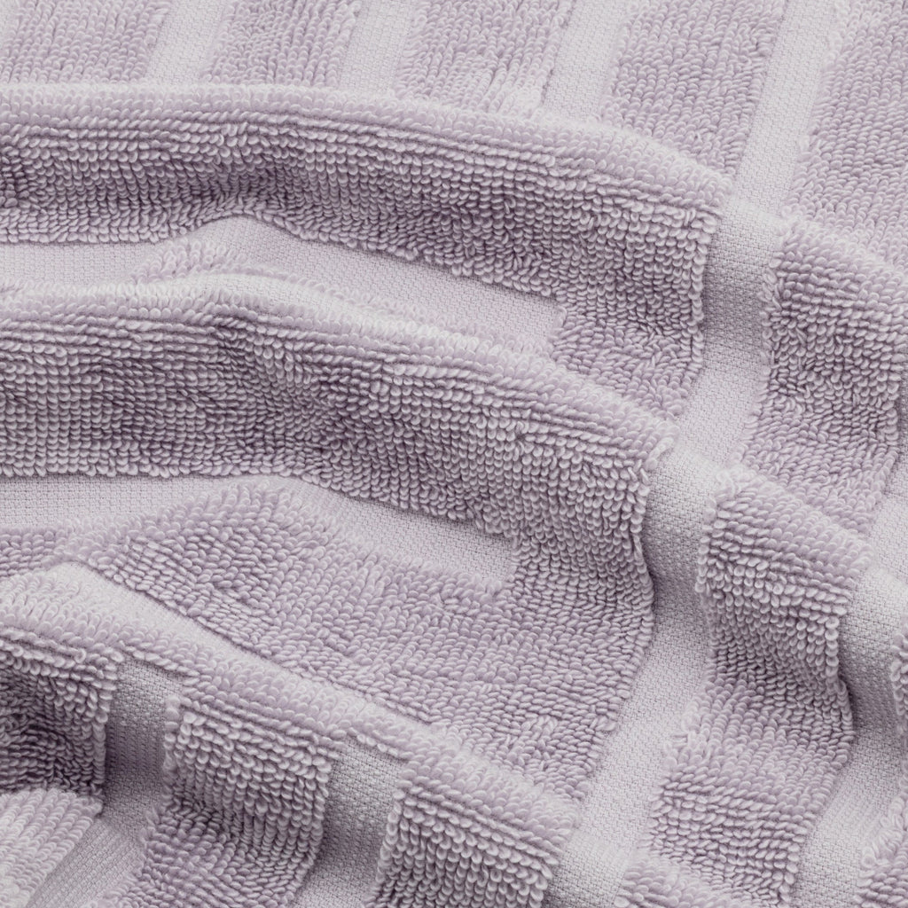 Lilac cotton towel with textured terry loops and striped design