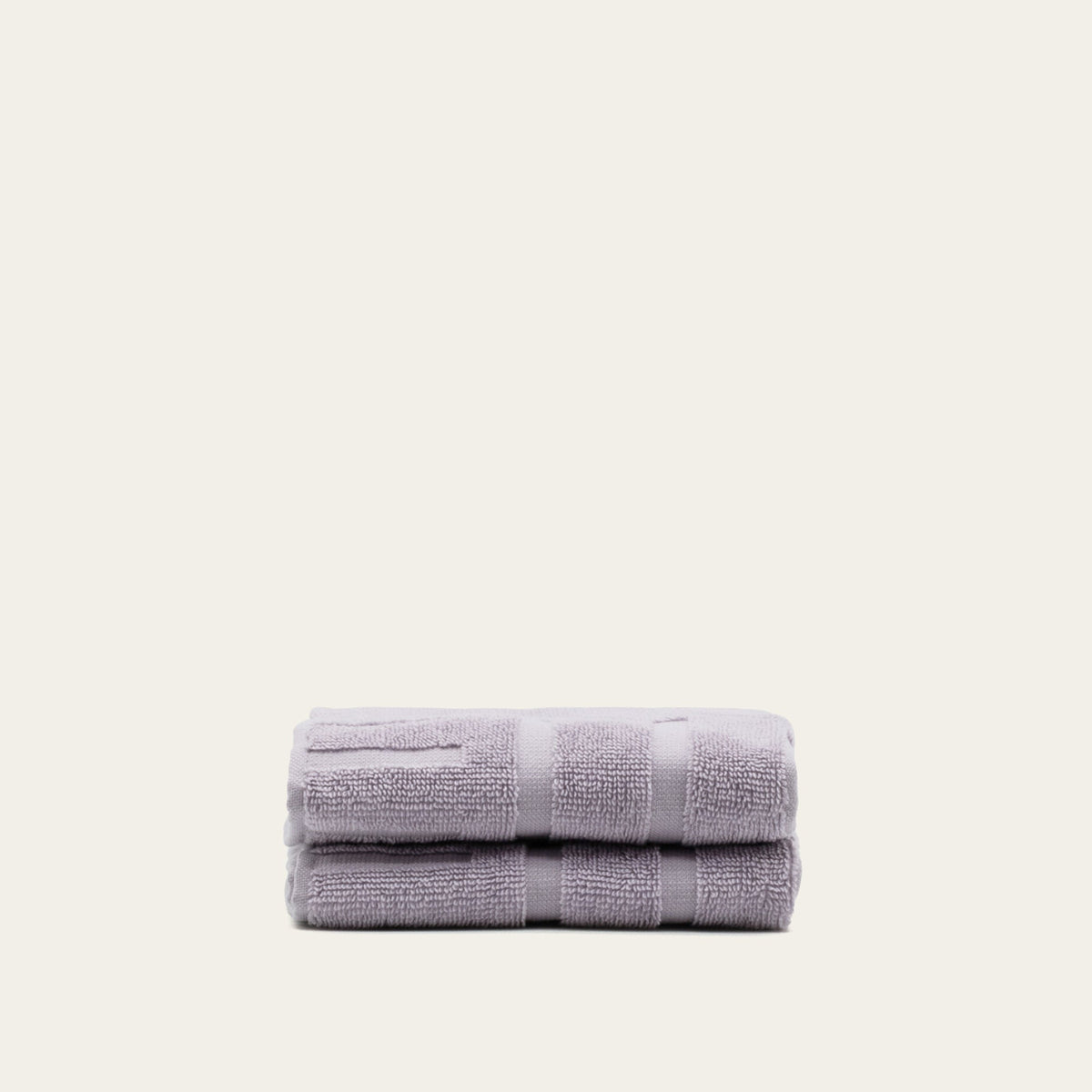 Lavender cotton towels, folded stack with terry texture and horizontal bands