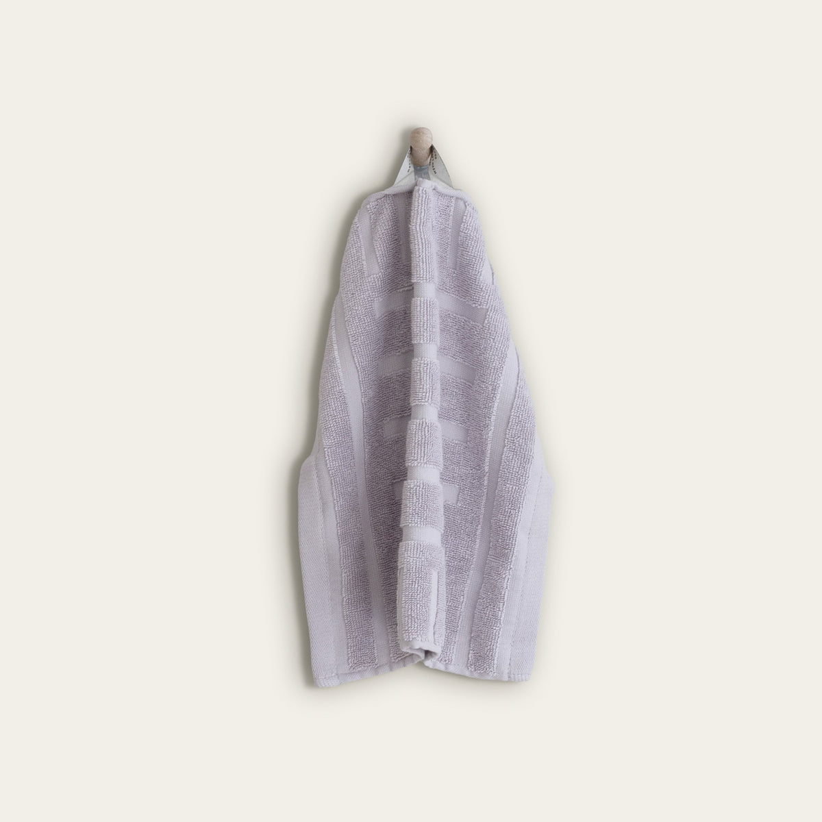 Lilac cotton towel folded with a striped center panel