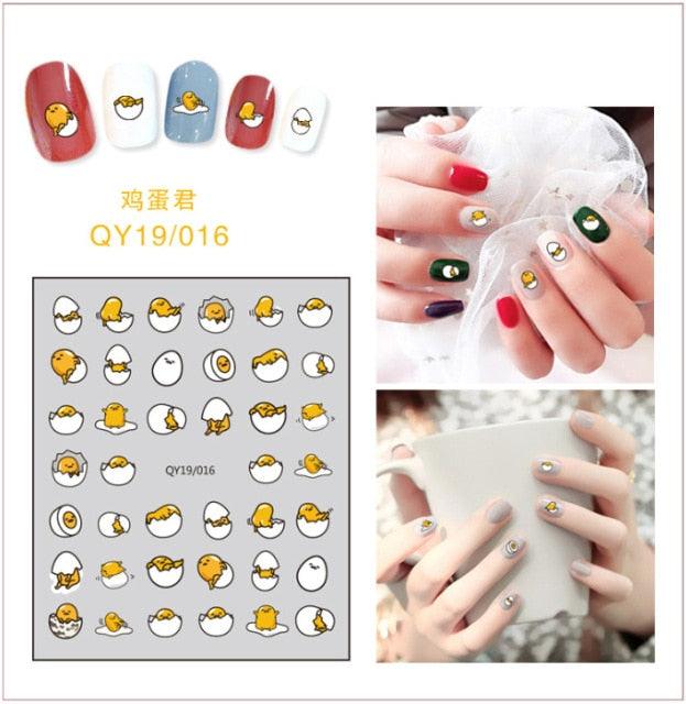 Chick and egg nail stickers with small cartoon faces and red accents