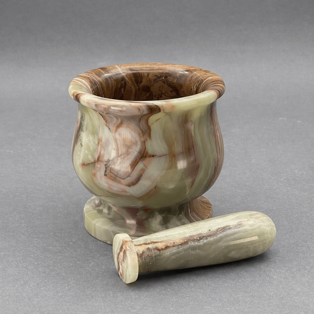Carved onyx mortar and pestle set, standing mortar with resting pestle, veined tones