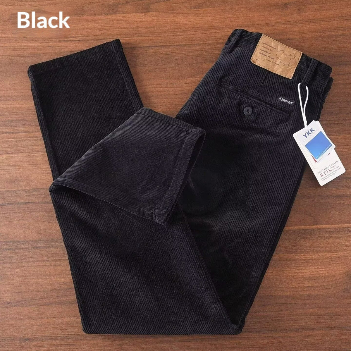 Men's corduroy straight-leg trousers in black with zip fly, button closure, and belt loops