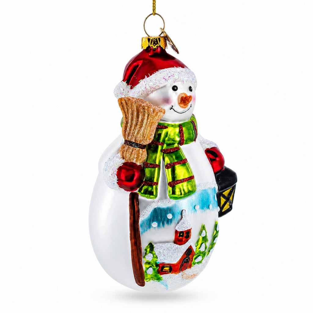 Glass Christmas ornament snowman holding broom and lantern, red hat, green striped scarf