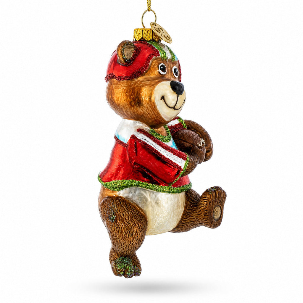 Football-themed bear glass Christmas ornament, side view with red helmet and gold hanger