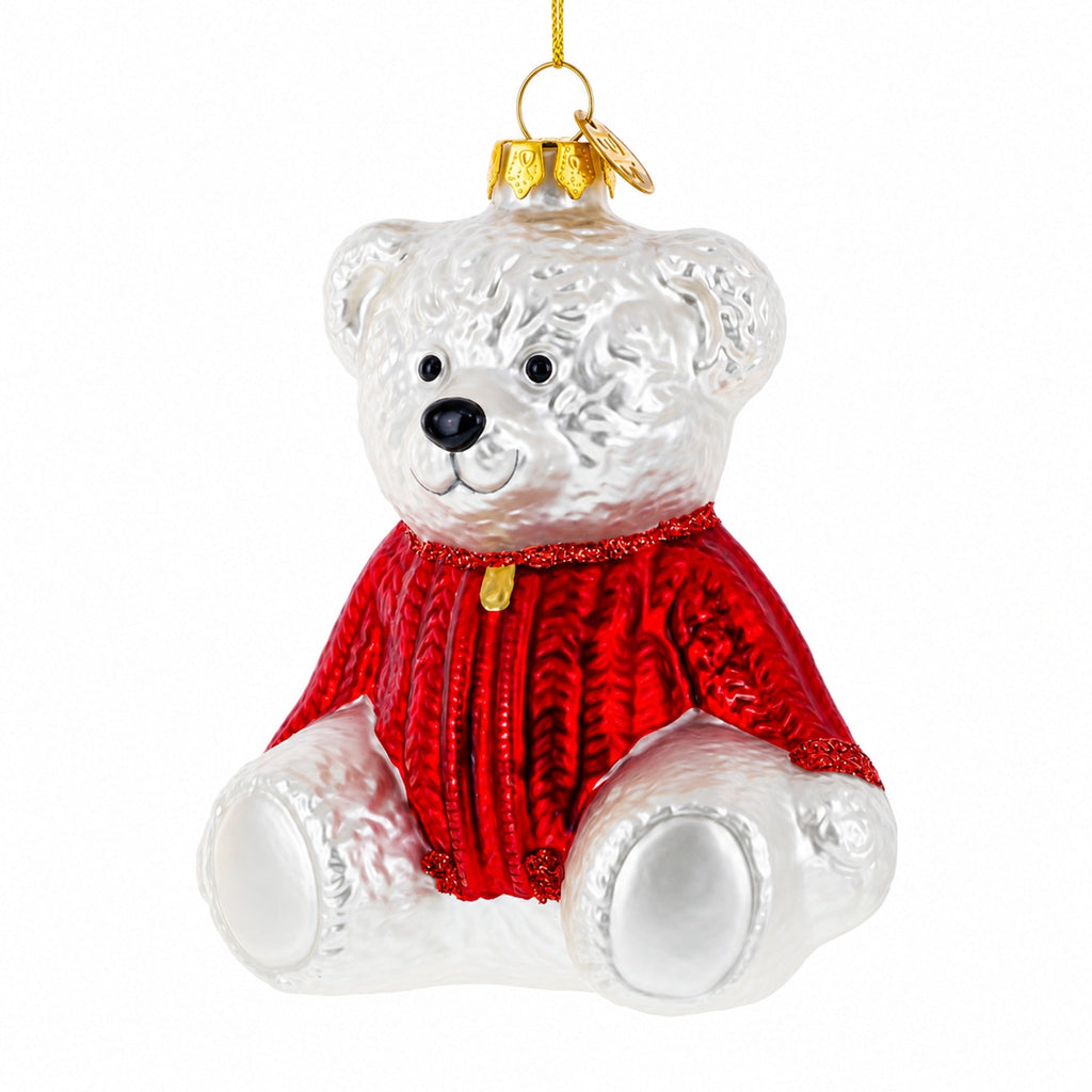 White teddy bear glass Christmas ornament wearing a red sweater, with gold hanging loop