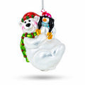 Glass Christmas ornament polar bear hugging penguin, red cap, silver chain