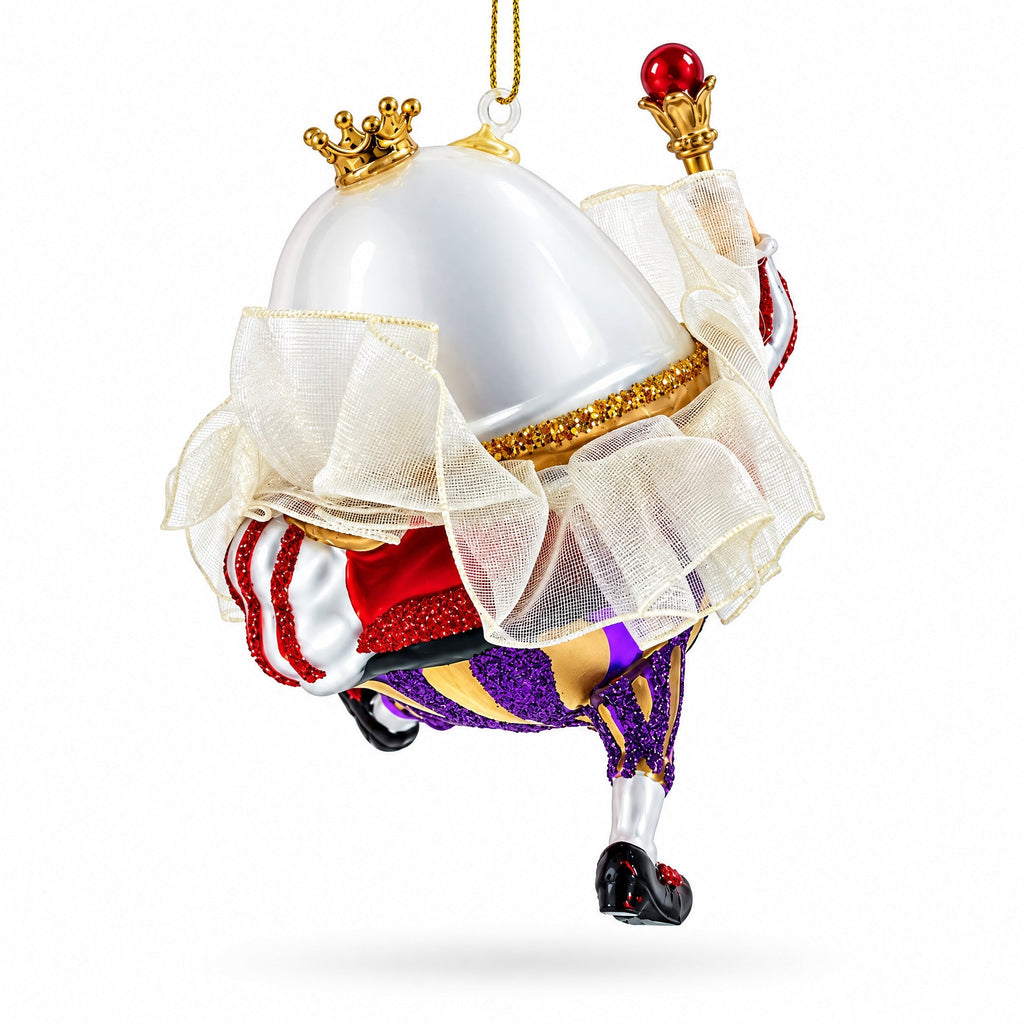 Glass king egg ornament, low angle: white robe, gold trim, red sash, purple glitter legs, hook