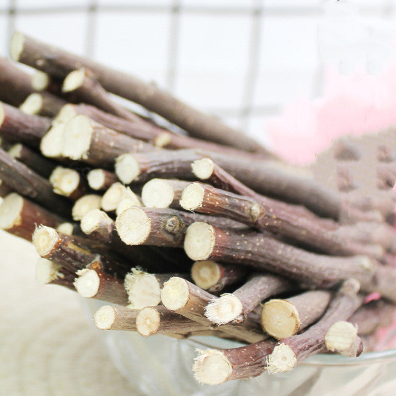 Dried branch pet treats close-up, dark brown sticks with pale trimmed ends