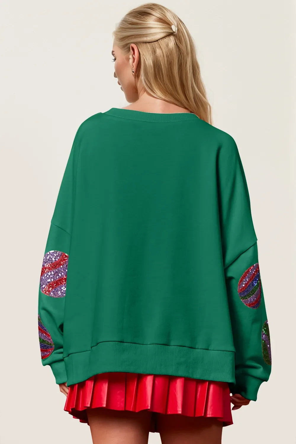 Dark green long-sleeve sweatshirt back view with sequin candy-cane heart patches