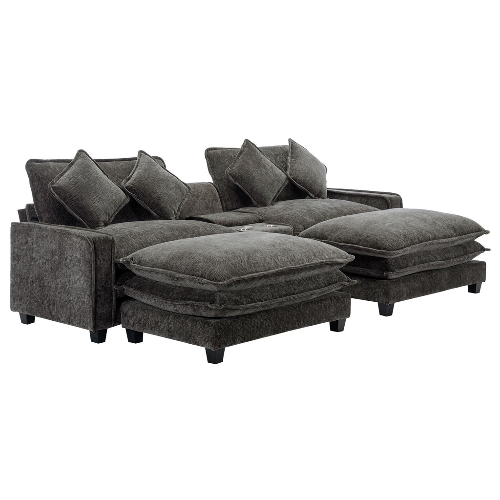 Dark gray sectional sofa with extended ottoman seats and multiple back throw pillows