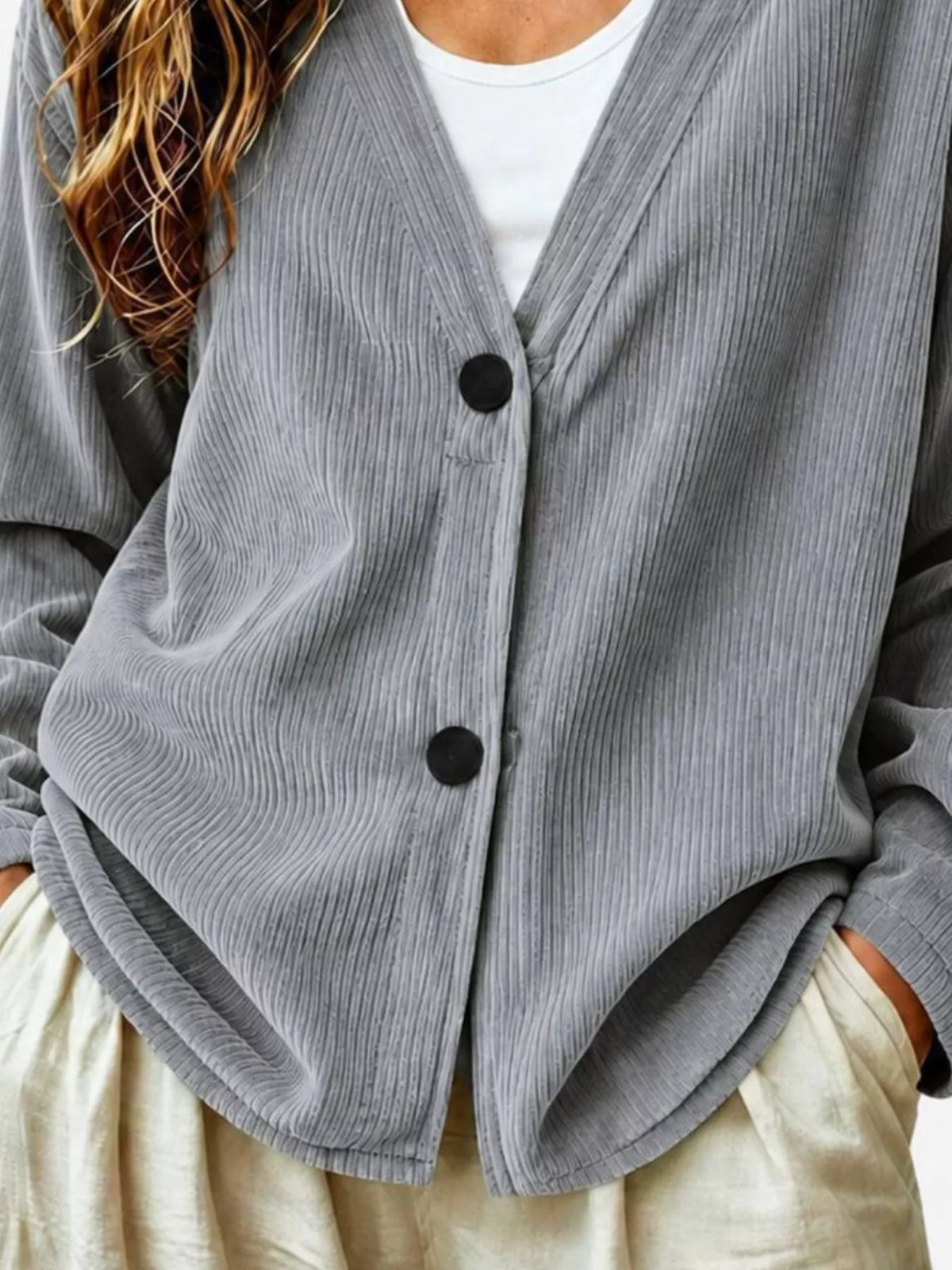 Gray corduroy button-up cardigan front detail with black button placket