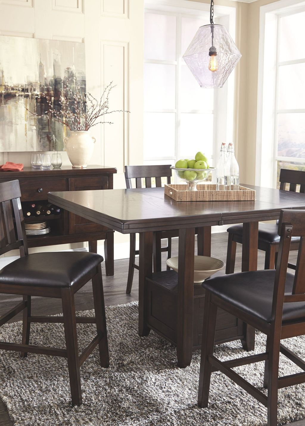 Dark brown dining table with side chairs and black upholstered seats around it