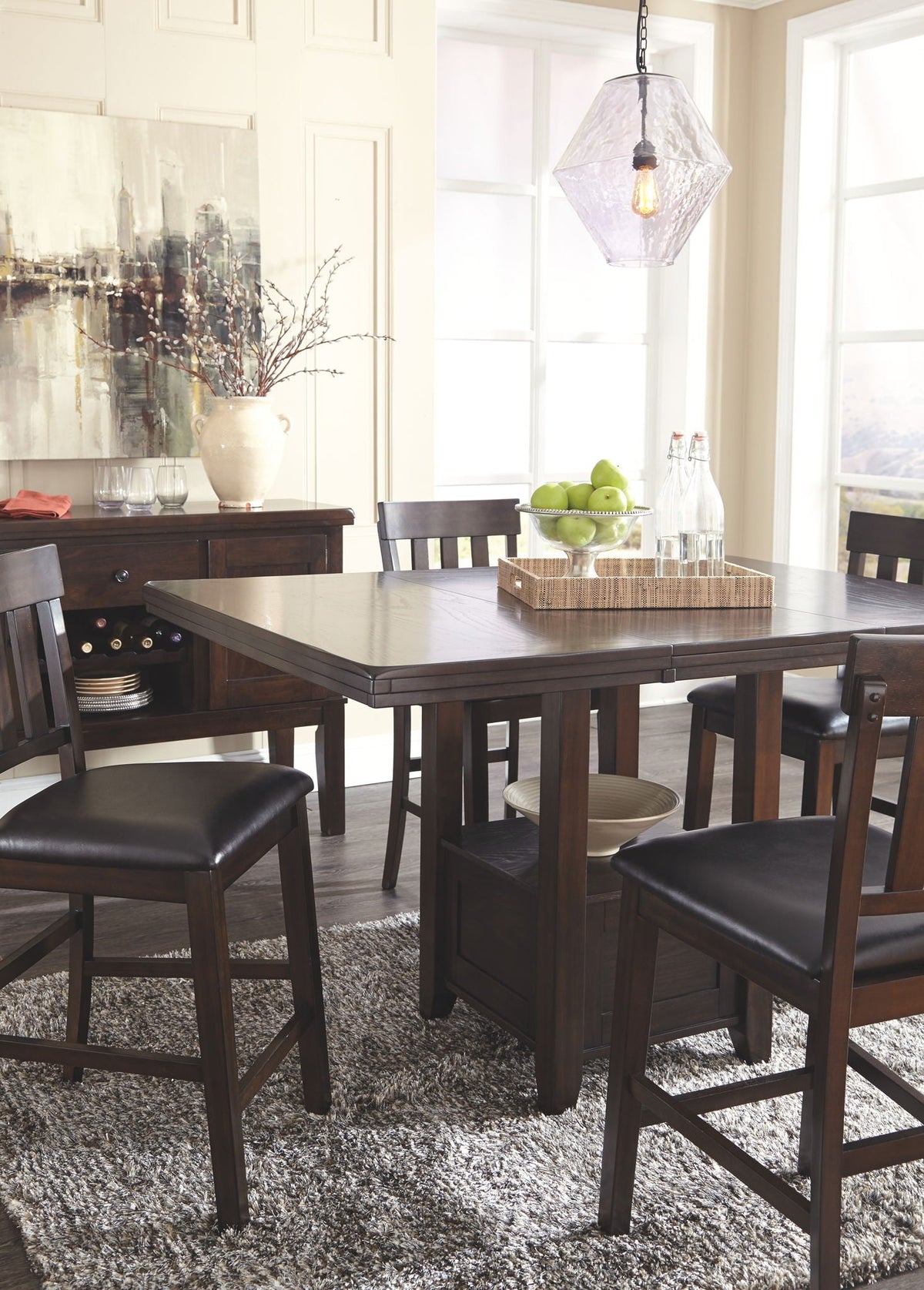 Dark brown dining table with side chairs and black upholstered seats around it