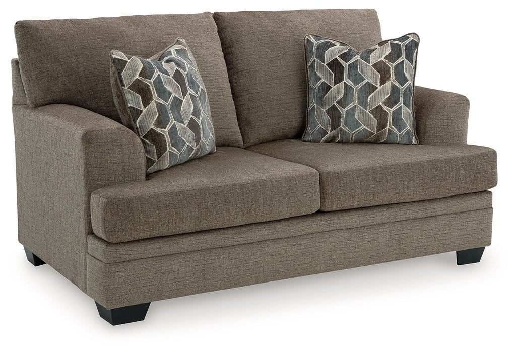 Brown loveseat with two throw pillows, tight seat, and black block feet