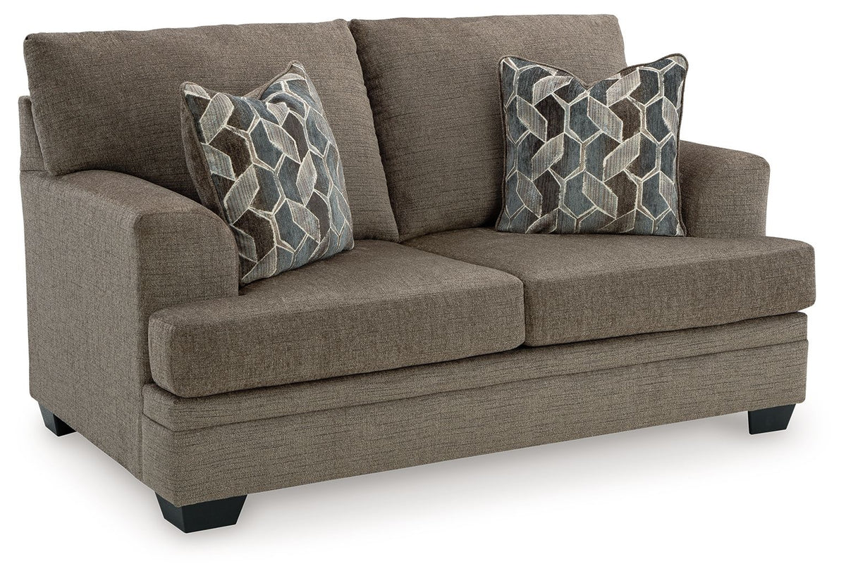 Brown loveseat with two throw pillows, tight seat, and black block feet