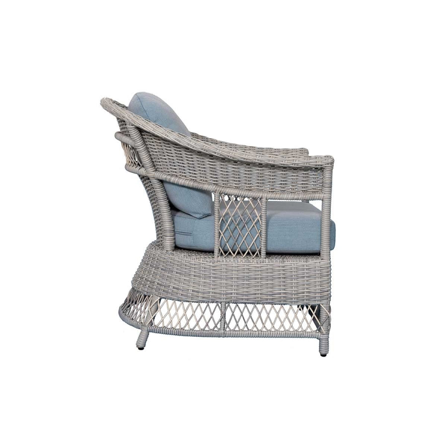 Side view stationary wicker lounge chair with light blue seat and back cushions