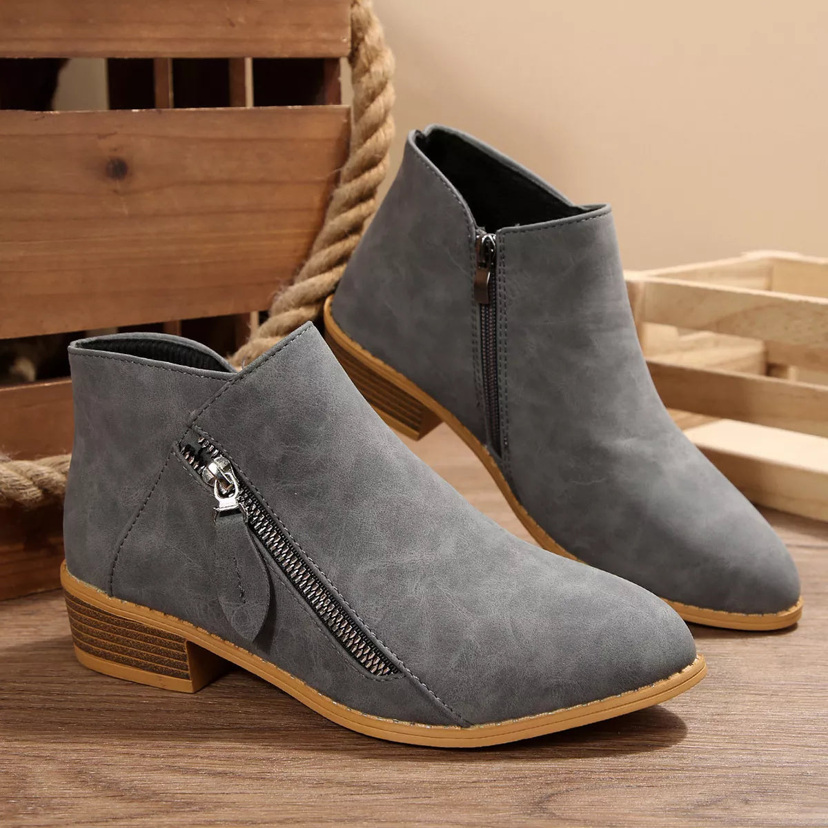 Dark gray ankle boots with side zipper, low block heel, tan rubber sole