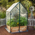 Cedar raised garden bed greenhouse with clear cover and green frame, arched door