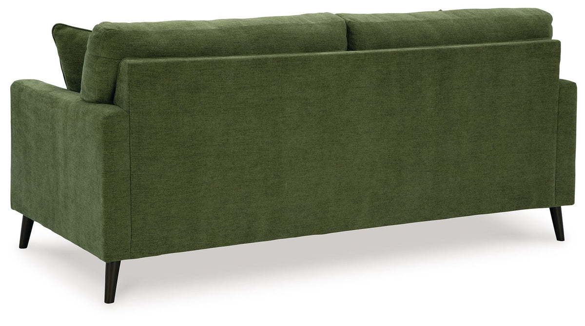 Green upholstered sofa from side angle with back cushions and tapered wood legs