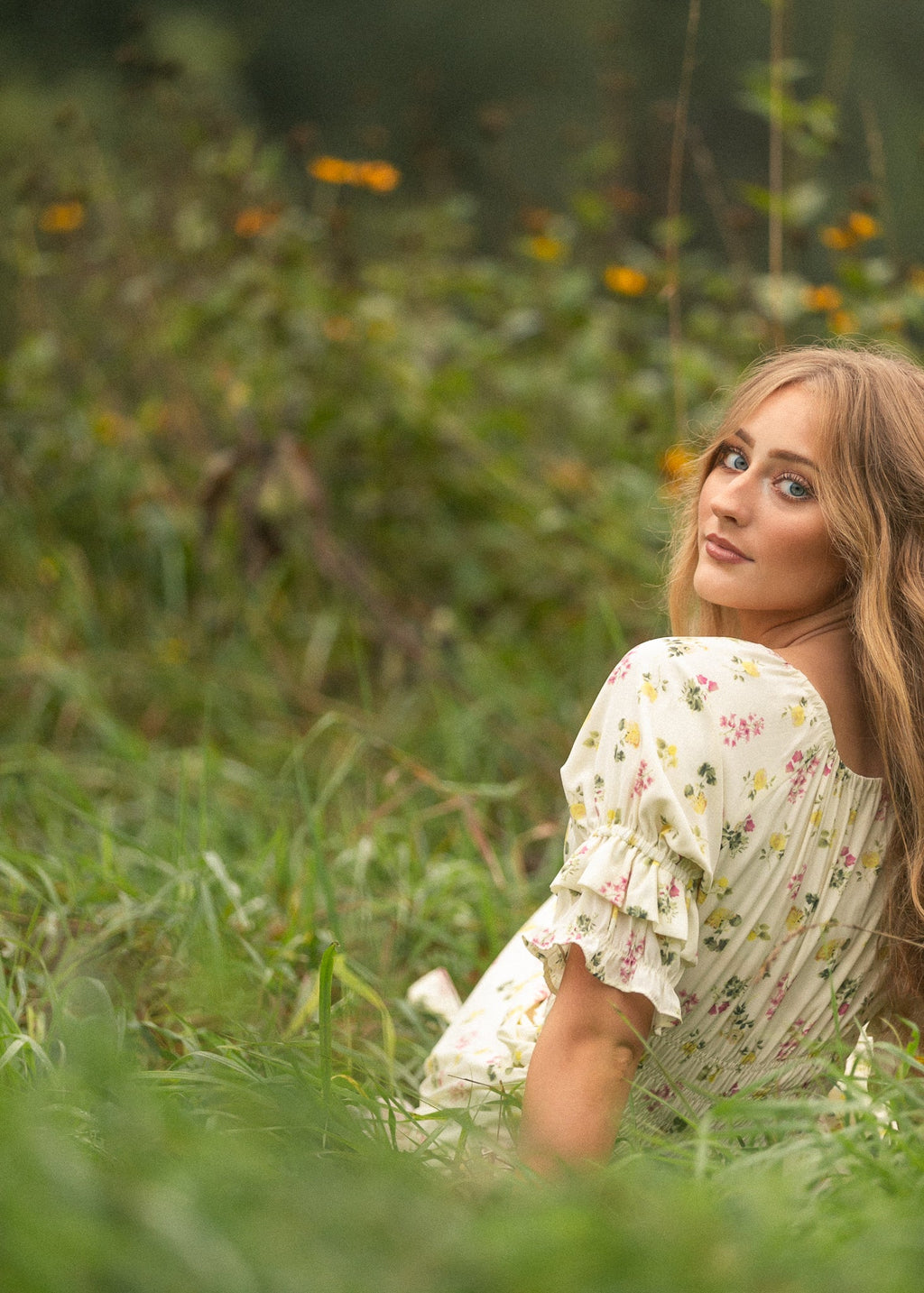 Floral maxi dress with puff sleeves, gathered bodice, and elastic waist, cream background.