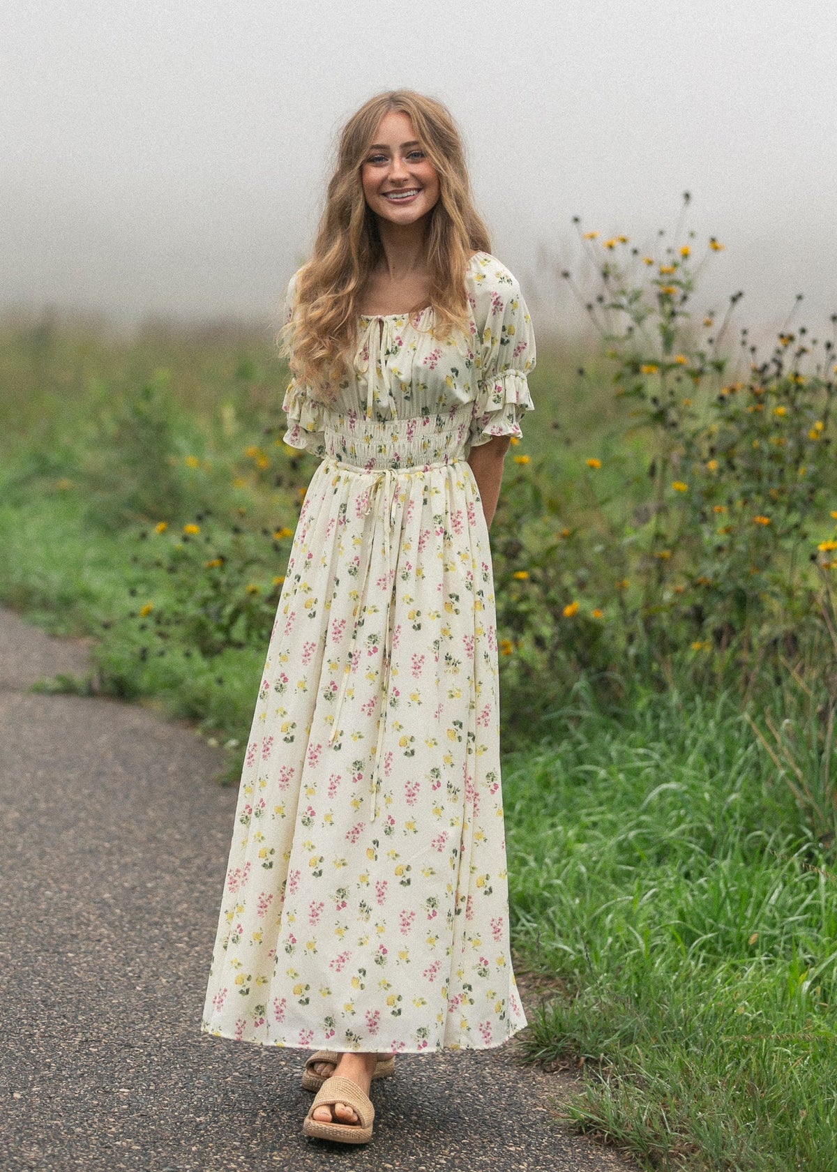 Floral maxi dress with puff sleeves and gathered skirt, cream with pink and green print.