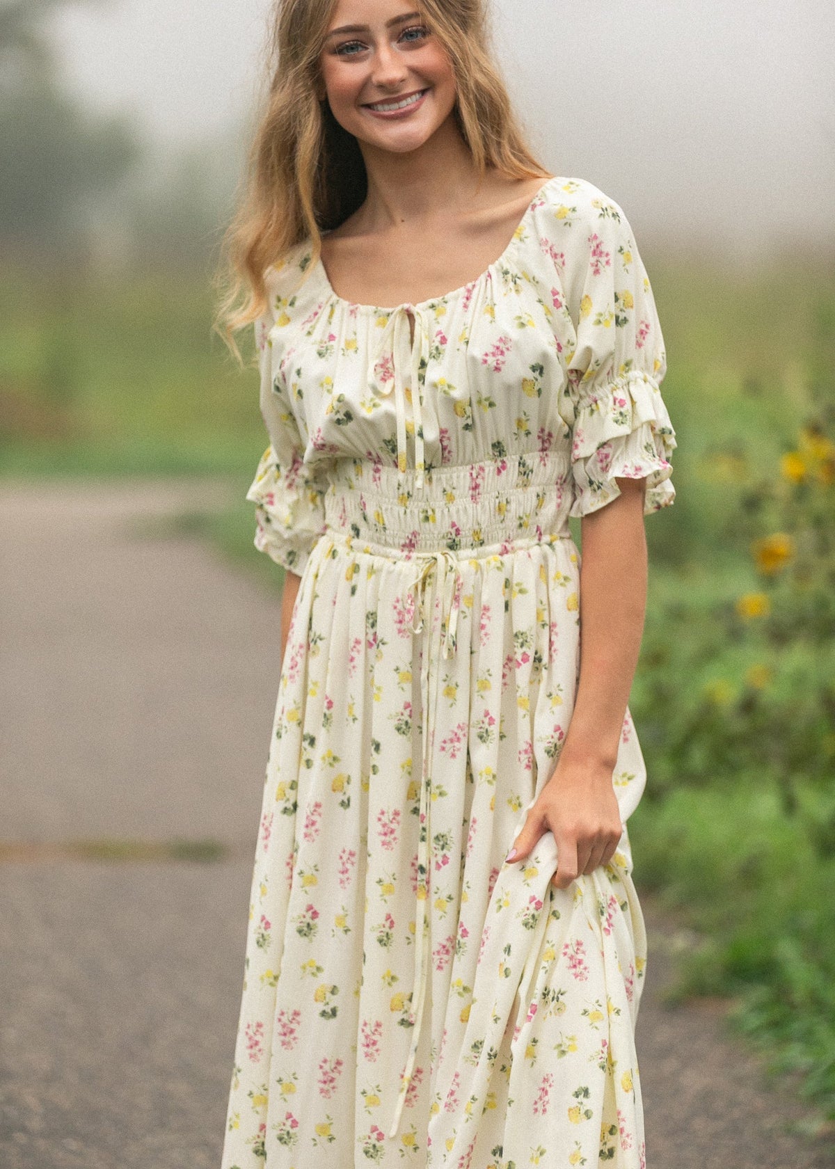 Floral maxi dress with puff sleeves and gathered ruffled neckline, cream base.