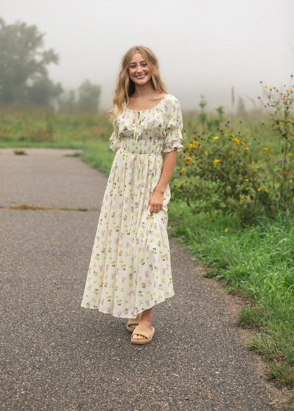 Ivory floral puff-sleeve maxi dress with elastic waist and swaying full skirt