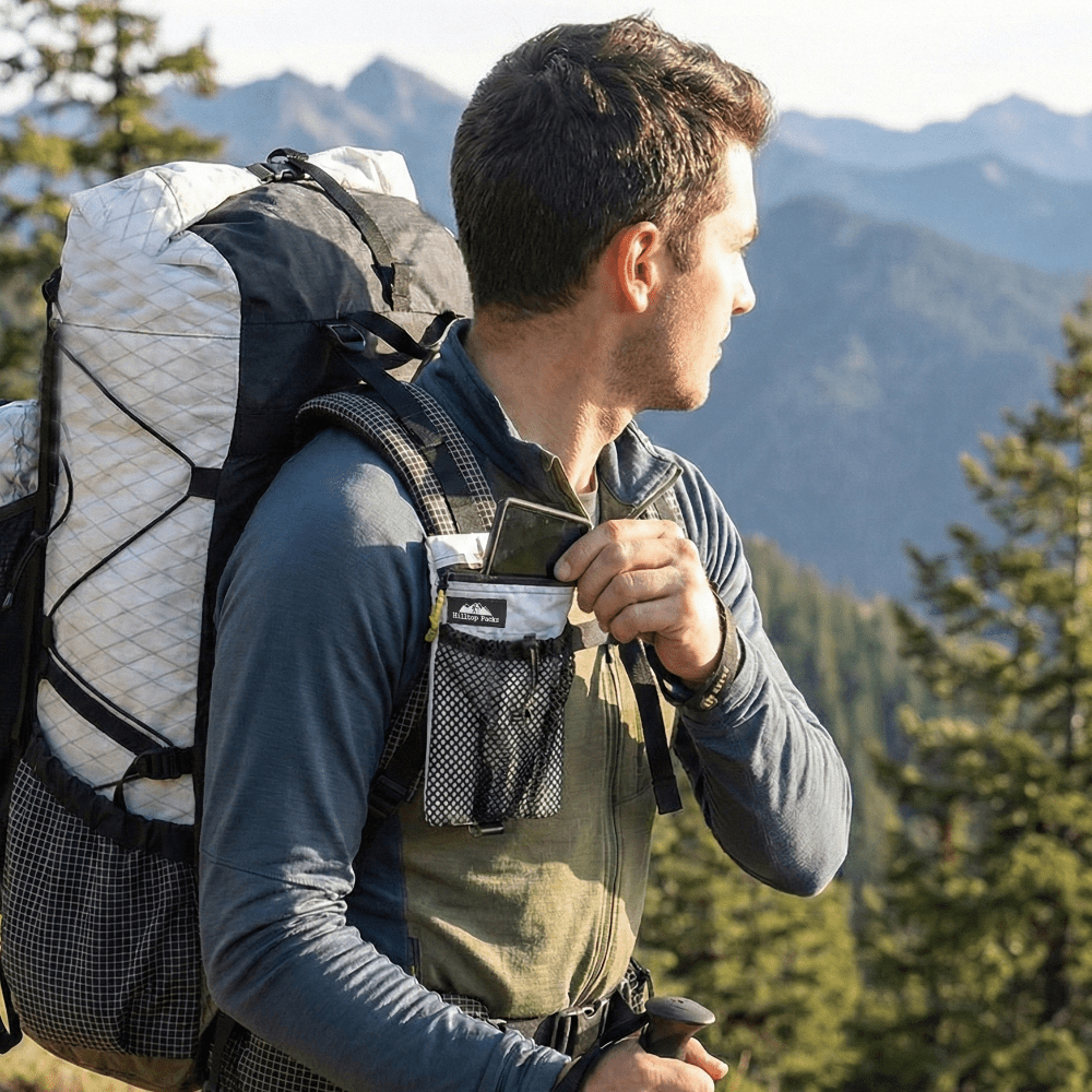 Backpack shoulder-strap phone pouch with zipper, worn on backpack strap
