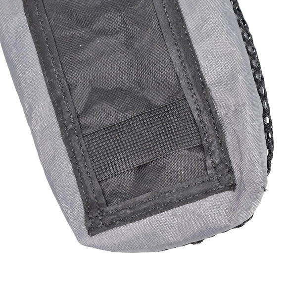 Close-up of gray cell phone pouch with stitched pocket and zipper pull