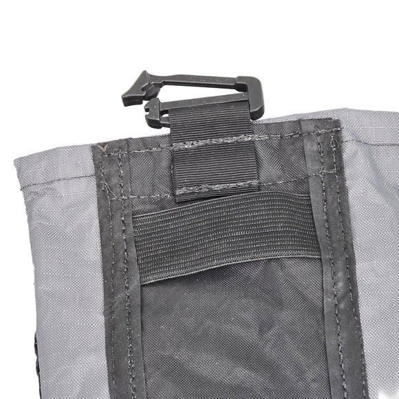 Close-up of gray cell phone pouch with interior mesh sleeve and strap hardware
