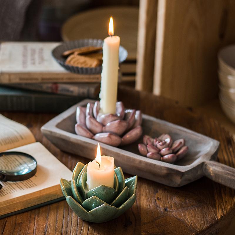 Ceramic succulent flower candle holder, teal, holds a lit pillar candle