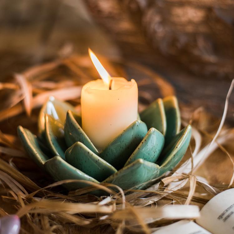 Ceramic succulent flower candle holder, teal, holds an upright lit candle