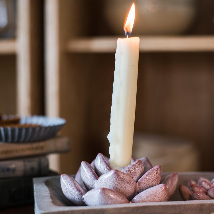 Ceramic succulent flower candle holder, pink/purple, holds an upright lit candle