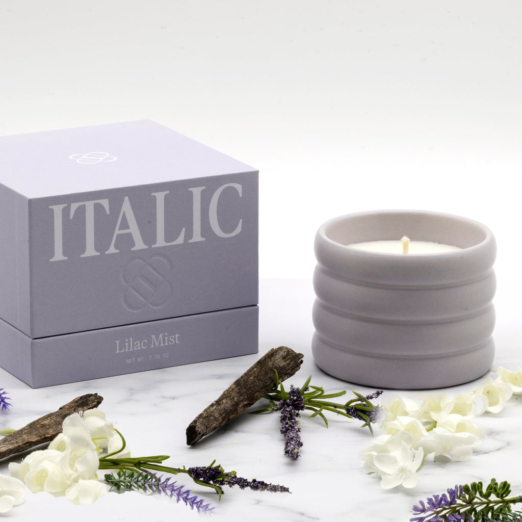 Lilac Mist ceramic soy candle set with gift box and lit candle in ribbed vessel.