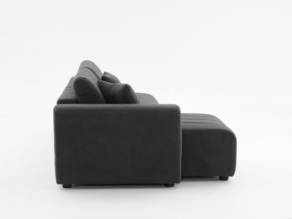 Dark gray sectional sofa with chaise, side profile with squared arm and ottoman-style end