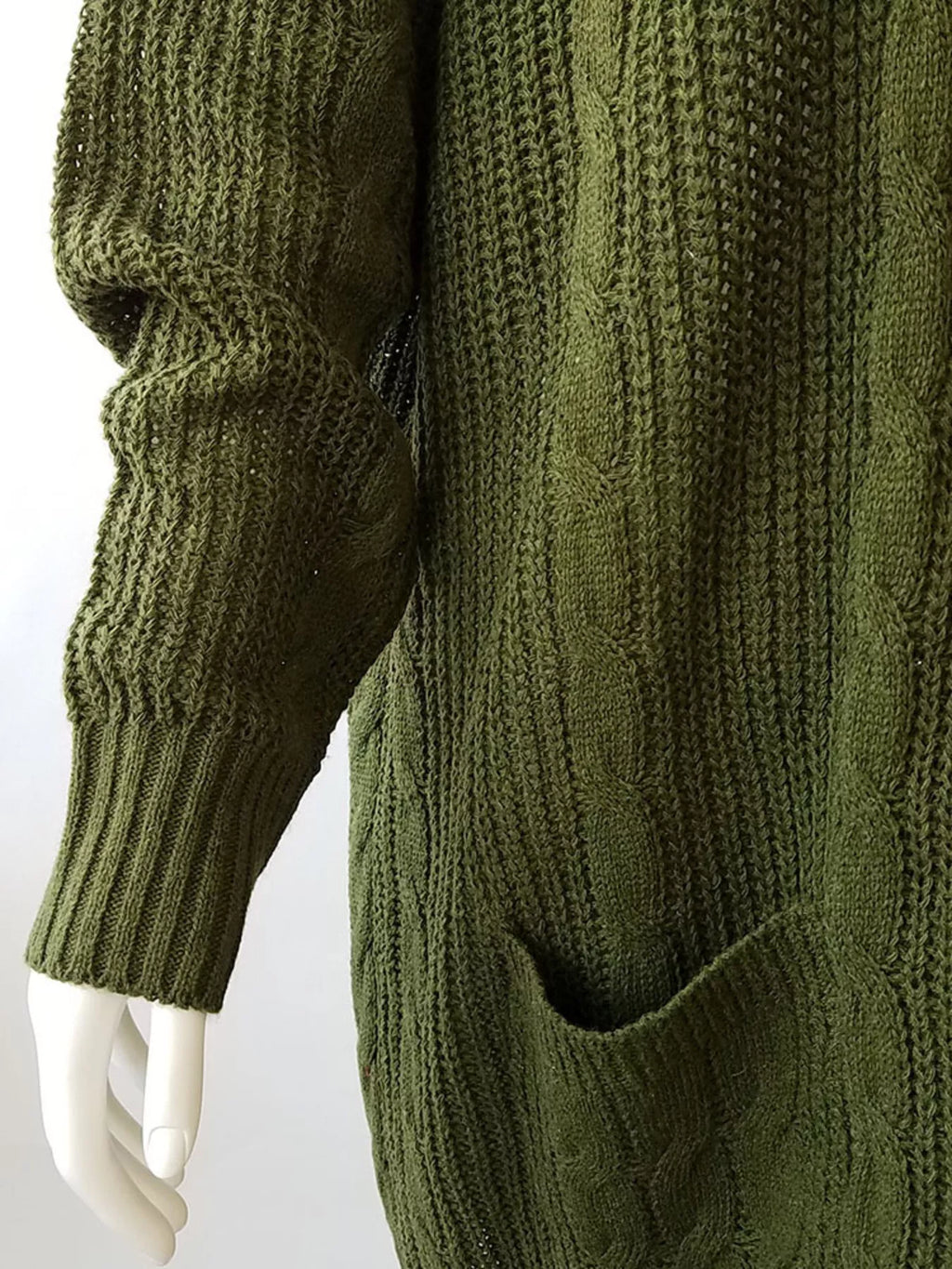 Green chunky knit open-front cardigan sleeve and pocket detail with textured cable knit