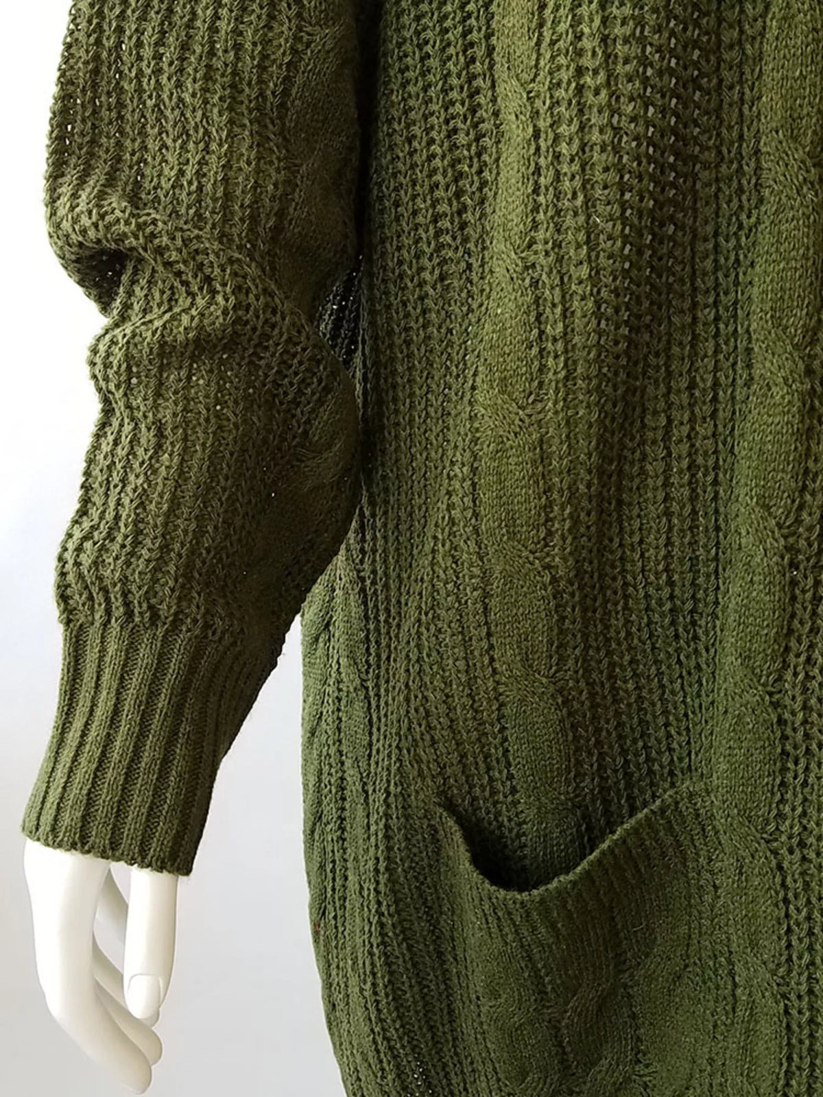 Green chunky knit open-front cardigan sleeve and pocket detail with textured cable knit