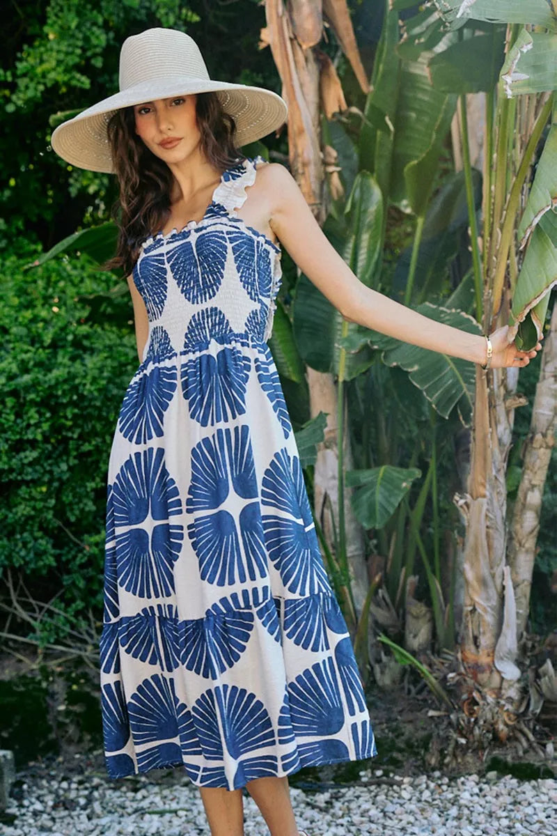 Front view of navy and white abstract print sleeveless midi dress with smocked bodice
