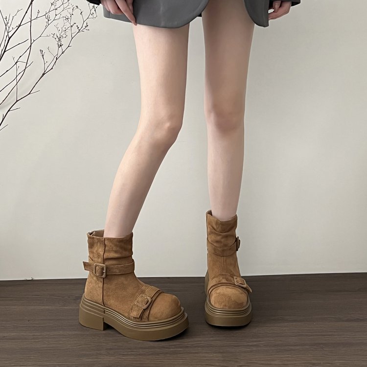 Pair of brown suede low ankle platform boots with buckle strap detailing