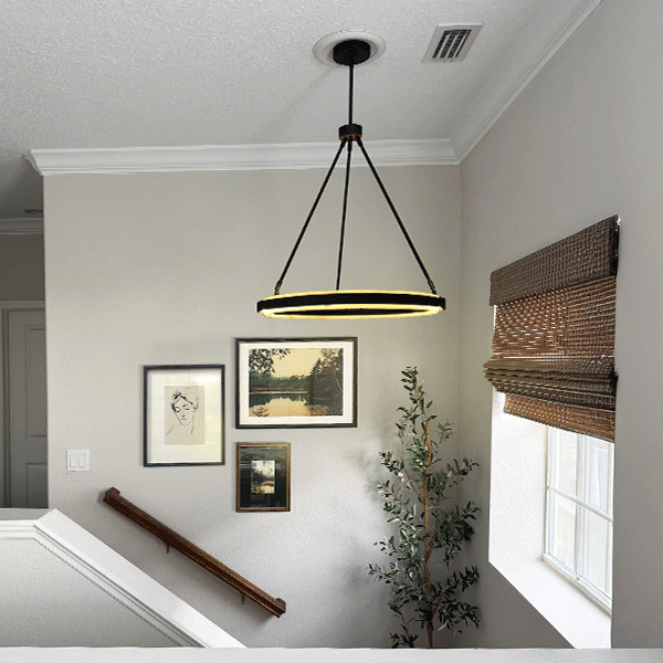 Black adjustable round LED chandelier with tripod cables and warm LED ring glow