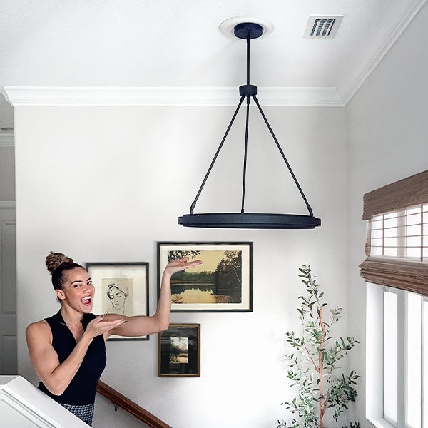 Adjustable round LED chandelier with black base canopy and glowing circular LED ring
