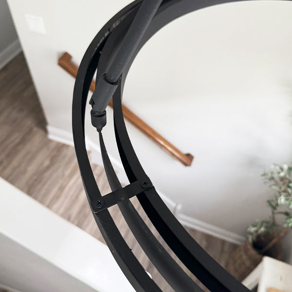 Black adjustable round LED chandelier arm and mounting straps on circular frame