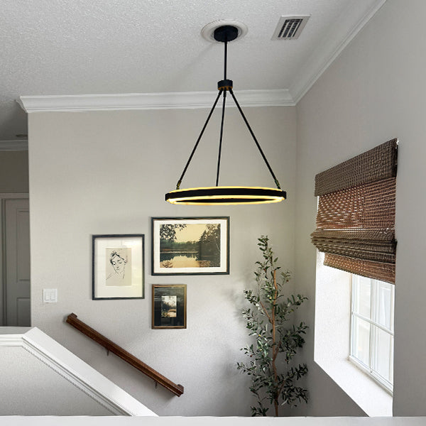 Black adjustable round LED chandelier with tripod rods and warm circular ring light